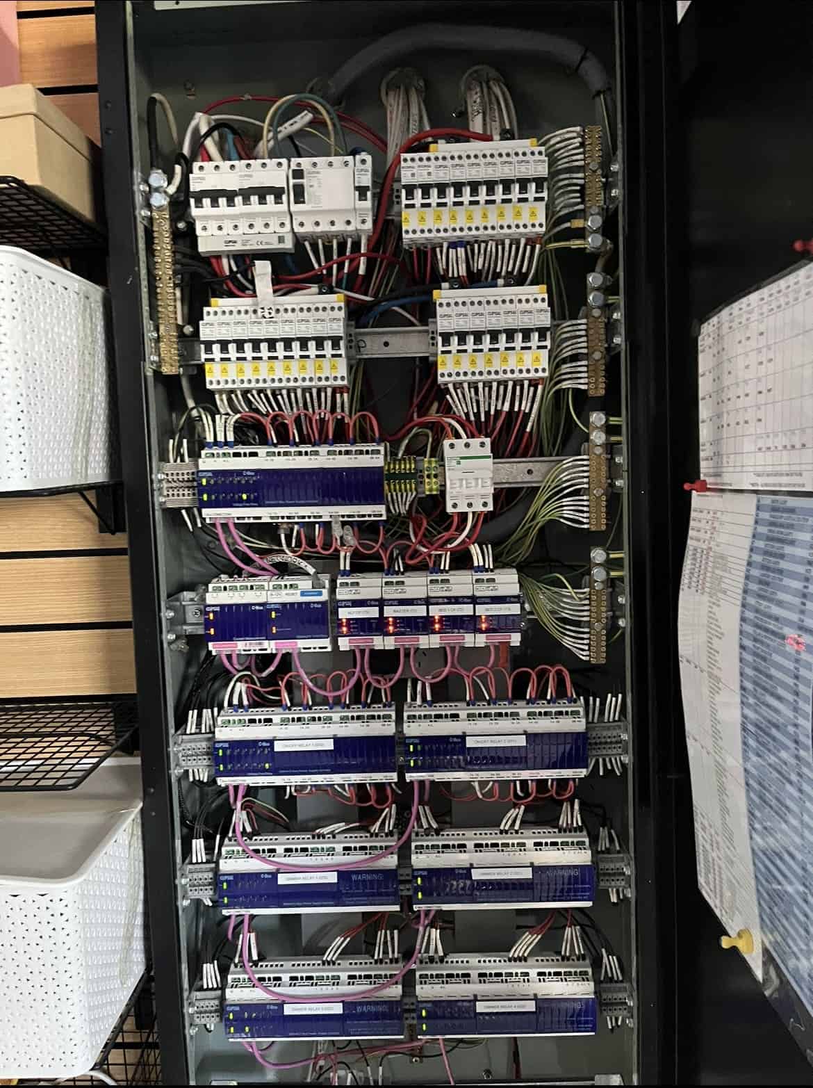 - Industrial electrical distribution board with circuit breakers on a sturdy metal surface inside.