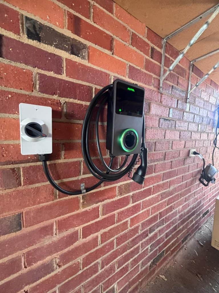 EV charging station mounted on a brick wall inside or outside of a building.
