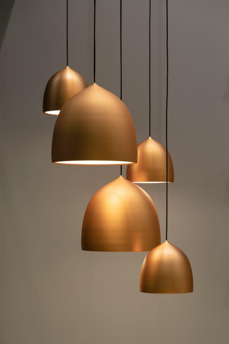 Bronze pendant lights hanging indoors from ceiling.