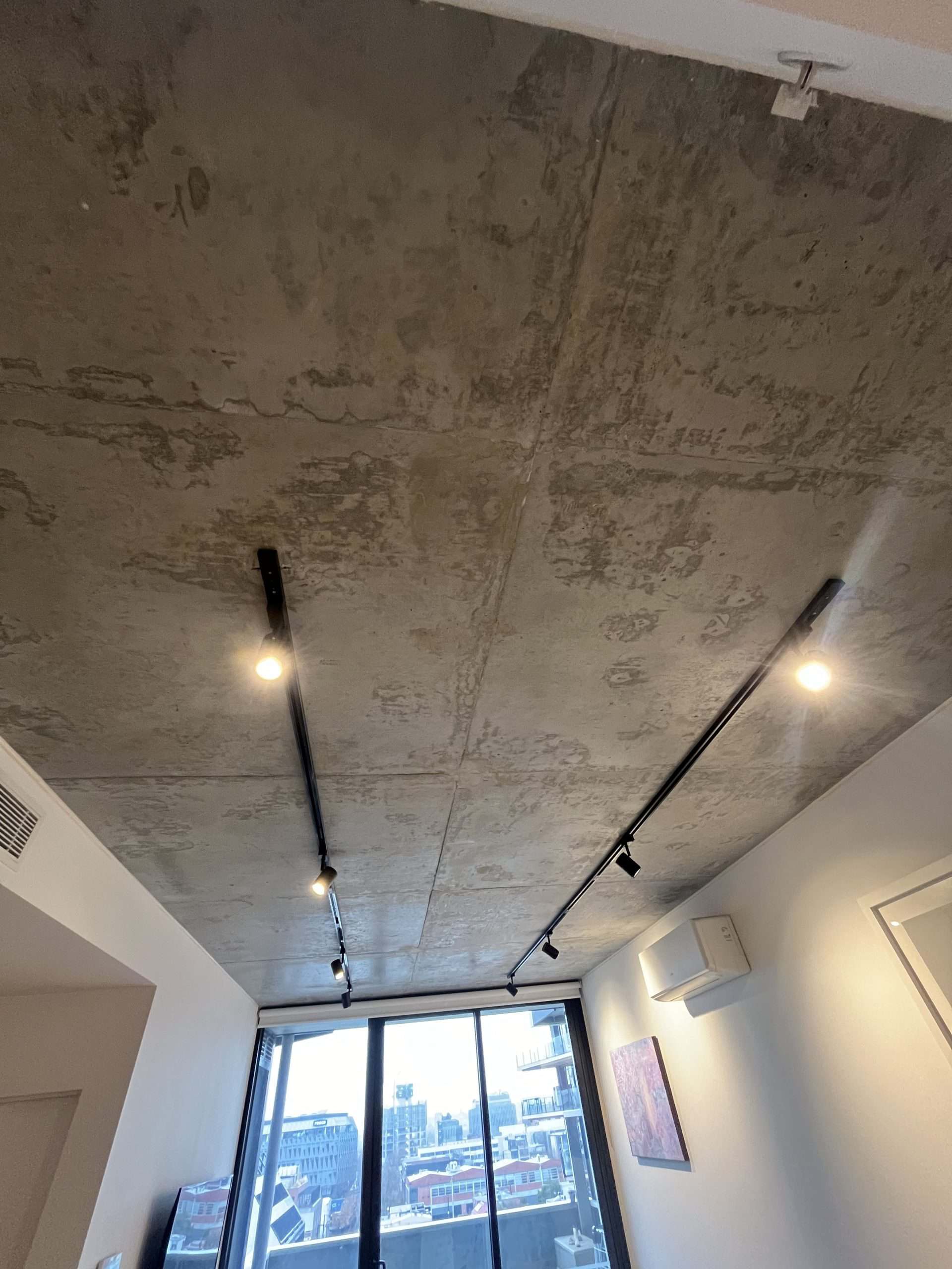 Washer on concrete ceiling in a modern apartment.